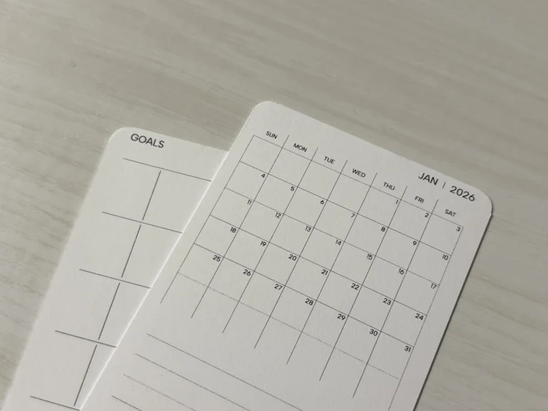 A Jan 2026 calendar card on another card of similar size with the text "Goals" on the top left corner.